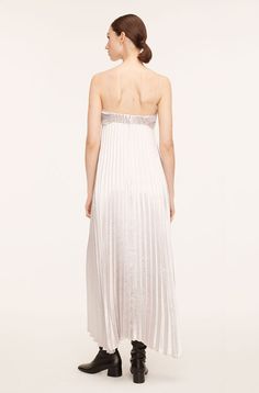 Guarantee you'll be the best-dressed guest: a head-turning spaghetti-strap dress in striking, radiant pleated lamé. Metallic Slip Dress For Summer Evenings, Metallic Maxi Dress For Summer Party, Summer Party Metallic Maxi Dress, Metallic Maxi Dress For Summer Evening, Metallic Maxi Dress For Evening In Summer, Glamorous Spring Slip Dress With Spaghetti Straps, Glamorous Pleated Maxi Dress For Night Out, Spring Shimmer Dress For Date Night, Metallic Summer Prom Dress