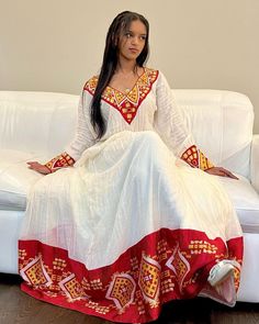 This Habesha Kemis, a traditional Ethiopian garment, radiates beauty and elegance, reflecting the rich cultural heritage and craftsmanship of Ethiopia. This exquisite dress showcases a perfect harmony of handwoven fabric, intricate embroidery, the use of Menen fabric, lightweight cotton, and quality thread, creating a stunning ensemble that captivates the eye and the heart. At the core of the Habesha Kemis lies the handwoven fabric, a testament to the skill and dedication of Ethiopian weavers. U Habesha Traditional Dresses, Zuria Habesha Dress, Ethiopia Clothing, Eritrean Clothing, Eritrean Dress, Mother Africa, Ethiopian Clothing, Habesha Dress, Ethiopian Traditional Dress