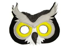 an owl mask with yellow eyes on a white background