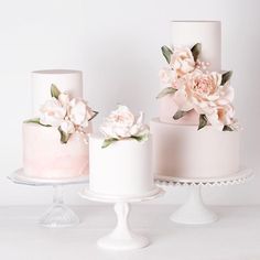 three different types of wedding cakes with flowers on each cake stand, one is white and the other is pink