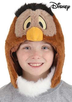 a young boy wearing a turkey hat and smiling at the camera with his eyes closed