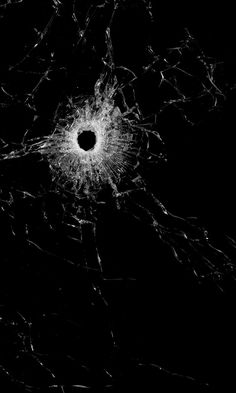 an image of a cracked glass in the dark