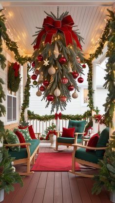 a porch decorated with christmas decorations and greenery