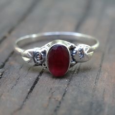 Handmade, Natural Raw (untreated) Ruby Sterling Silver Botanical Ring Featured in this listing are Sterling Silver, handmade, natural stone rings. These lovely ring feature a beautiful, Natural untreated Ruby oval 6x4(approx.) stones. All hand set into .925 Sterling Silver. Please note that there will be natural inclusions, as this ring is untreated, and in it's purest form. There are slight color difference due to nature of each unique stone. Detailed leaf design along each side of the stone, w Adjustable Red Sterling Silver Stackable Rings, Spiritual Red Sterling Silver Ring, Red Untreated Rings As A Gift, Untreated Red Rings For Gift, Untreated Red Rings As A Gift, Spiritual Red Ruby Ring In Sterling Silver, Handmade Adjustable Ruby Ring In Sterling Silver, Spiritual Sterling Silver Ruby Promise Ring, Red Sterling Silver Flower Ring As Gift