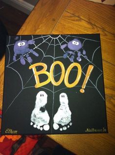 a halloween card with the words boo and two ghost hands in front of a spider web