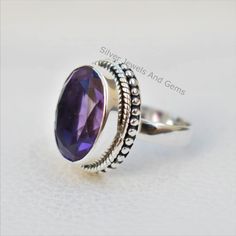 Gemstone-Amethyst Shape-Oval Stone Size - 10x14 MM Metal-925 Sterling Silver This One of a kind ring is adorned with beautiful Purple Amethyst Gemstone in sterling silver.Amethyst is the birthstone representing the month of February. About gemstone-.Amethyst is linked to the element of wind.It is believed to prevent intoxication.This purple gemstone is associated with Royalty.This stone has amazing healing power and very helpful in purifying the mind and relieving stress.Amethyst is the stone of Silver Amethyst Ring With Oval Accent Stones, Oval Purple Ring With Bezel Setting, Purple Oval Stone Set Ring, Purple Oval Stone Setting Rings, Purple Oval Ring With Stone Setting, Adjustable Oval Hallmarked Crystal Ring, Fine Jewelry Amethyst Ring In Sterling Silver Oval Shape, Fine Jewelry Amethyst Ring With Oval Stone Setting, Oval Gemstones With Stone Setting For Anniversary