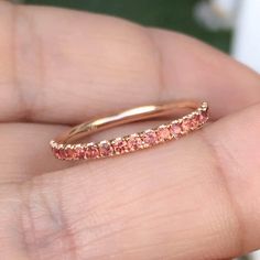 "Half Eternity Micro Pave Band with Orange Sapphires. MaterialSolid Gold (14K/18K) or Platinum 950 FinishingShiny PlatingRhodium/ Platinum Family (Only if white gold selected) FitComfort/ Rounded Interior Width2 mm Height2 mm Setting TypeU Micro Pave Set (Reminds the Letter \"U\" from sides) StonePadparadscha Sapphire QualityAAA Total Carat Weightapx 0.40ct Quantity of Stonesapx 19 (varies by ring size) Click below to add laser engraving. https://www.etsy.com/listing/631070916/laser-engraving?ga Rose Gold Ruby Ring With Halo For Anniversary, Rose Gold Halo Sapphire Promise Ring, Rose Gold Sapphire Ring With Halo, Rose Gold Stackable Sapphire Ring, Stackable Rose Gold Ruby Ring For Anniversary, Stackable Rose Gold Sapphire Ring, Stackable Pink Ruby Ring For Wedding, Rose Gold Stackable Ruby Ring For Anniversary, Rose Gold Sapphire Ring For Wedding With Round Band