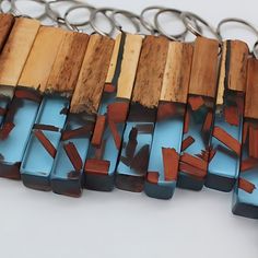 several pieces of wood and metal are arranged on a white surface with key chains attached to them