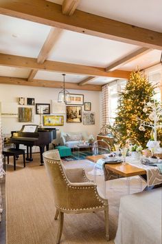 a living room filled with furniture and a christmas tree