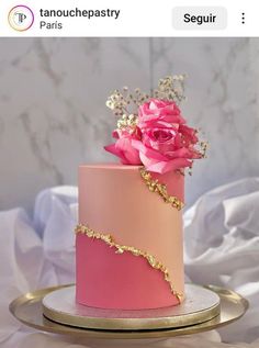 a pink and gold wedding cake with flowers on top is featured in an instagram