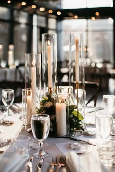 the table is set with candles and place settings