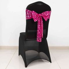 a black chair with a pink bow on it