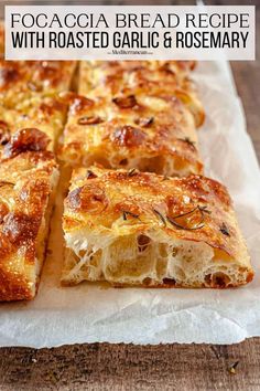 a close up of bread on a piece of parchment paper with text overlay that reads focaccia bread recipe with roasted garlic and rosemary