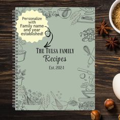 the tulsa family recipe book sits on a table next to an egg and spices