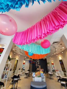 colorful streamers and balloons hang from the ceiling