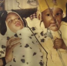 an old photo of two children with hats on