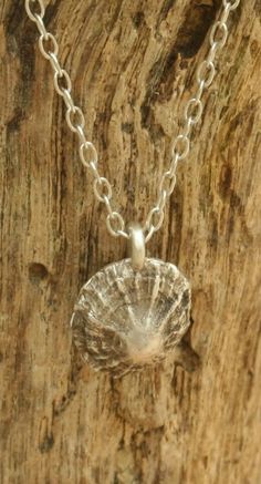 Delicate fine silver Limpet shell moulded in precious metal clay from a real shell found on the beach in South Wales. Oxidised to better show off the intricate detail of the shell. It hangs from a long sterling silver trace chain. Comes in one of our branded boxes. Handmade in our workshop in the Cotswolds. If you choose standard postage, we will send your order by Royal Mail first class signed for, which should arrive within 1-2 working days. If you choose the express option, we will send your Handmade Silver Shell Pendant, Handmade Silver Pendant Shell, Silver Shell Necklace For Gift, Ocean-inspired, Silver Engraved Necklace For Beach, Silver Shell Pendant For Beach, Handmade Silver Shell As A Gift, Silver Beach Pendant Shell, Handmade Sterling Silver Shell-shaped Necklace, Unique Silver Shell-shaped Necklace