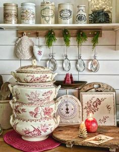 a kitchen counter topped with lots of pots and pans on top of wooden shelves