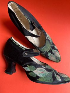 These are something else.  I think I can safely say they are definitely one of a kind.  They date from the 1920s and are hand painted, skilfully.   The shoes are black silk with a low 65mm/2.5 inch, chunky, Louis heel.  They have a slightly rounded pointed toe and a single strap over the instep with glass button closure.  They are lined with a combination of white kid leather and fabric.  They were obviously a quality shoe. What makes them really stand out is the handprinted arum or calla lily d Silk Shoes, Lily Design, Hand Painted Shoes, Painted Silk, Calla Lily, Black Paint, Black Silk, Pump Shoes, Teal Blue