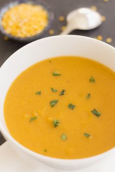 a white bowl filled with soup on top of a table