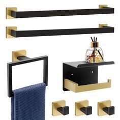 black and gold bathroom accessories including soap dispenser, towel rack, toilet paper holder