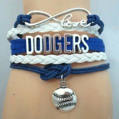 three different bracelets with baseball charms on one wrist and love dodgers charm on the other