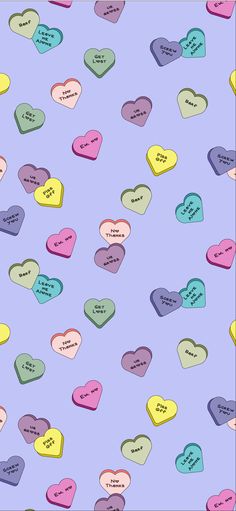 many hearts with words written on them are shown in different colors and sizes, including pink, blue, green, yellow, and purple