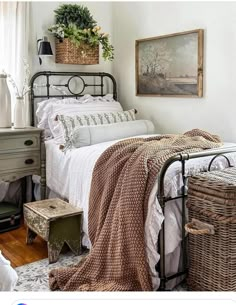 a bed room with a neatly made bed and wicker baskets on the headboard