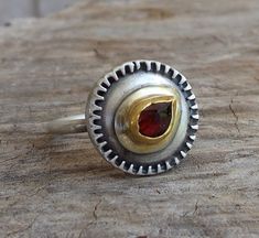 Garnet Ring - One of a kind Garnet ring - the stone set in 24k solid gold on top round sterling silver band 1.5mm wide in Matte finish. The Garnet rose Cut drop stone size is 4/7mm The ring size is 8US or 57Uk. The Ring will be packed in lovely a gift box and will be ready to be given as a gift or kept for yourself. Free Shipping Your item will be shipped via registered air mail with tracking number. Please contact me with any questions or requests. my Sterling Silver Hidden Seeds Collection at Unique Dome Ring With Gemstone For Anniversary, Unique Gemstone Dome Ring, Unique Ruby Ring With Bezel Setting For Anniversary, Unique Hallmarked Round Topaz Ring, Unique Rings With Round Stone For Anniversary, Unique Anniversary Rings With Round Stone, Unique Sterling Silver Cluster Ring, Unique Round Bezel Set Birthstone Ring, Unique Topaz Ring With Stone Setting