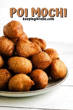 a white plate filled with fried food on top of a wooden table