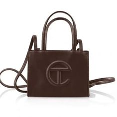 Brand New! Telfar Small Shopping Bag In Chocolate. "The Iconic Unisex Shopping Bag Is An Everyday Bag For Everyone. Featuring A Double Strap (Handles And Cross-Body Straps), Embossed Logo, And Magnetic Snap Closure. Made From Faux Leather And Twill Lining. Bag Is Packaged In A Drawstring Bag With Screen-Printed Logo." Height 4 3/4", Width 6 5/8", Depth 3", Strap Drop 21", Handle Drop 4 3/4" 50% Polyurethane, 50% Polyester Telfar Brown, Chocolate Bag, Telfar Bags, The Afterparty, Telfar Handbags, Cotton Drawstring Bags, Medium Tote, Small Crossbody Bag, Shopper Bag