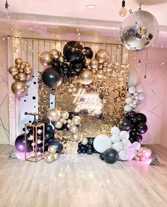 a room filled with balloons and disco balls