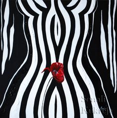 a red flower sitting on top of a black and white striped wall