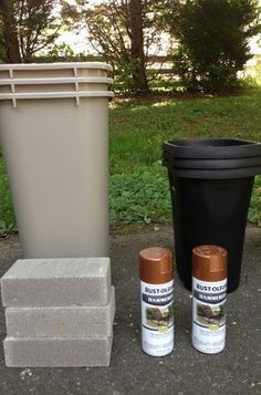 two cans, one black and one brown next to a trash can