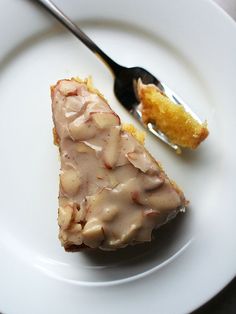 a piece of cake sitting on top of a white plate with a fork next to it