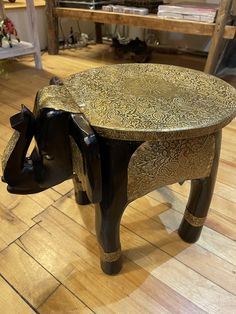 an elephant shaped coffee table sitting on top of a hard wood floor