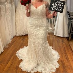 a woman in a wedding dress holding a sign that says i said yes to the bride