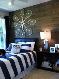 a bed room with a neatly made bed next to a window and a painting on the wall