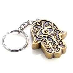 a metal key chain with a hamsah design on it's front end