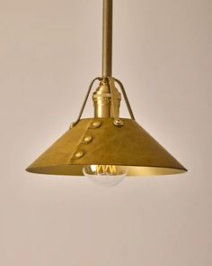 a brass colored light hanging from a ceiling