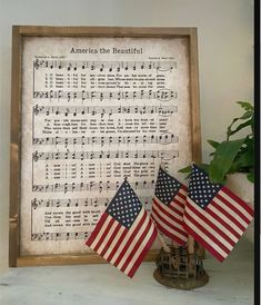 two american flags sitting next to an old sheet music