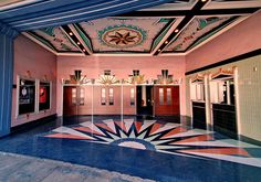 the inside of a building with an art deco floor and colorful decorations on the ceiling