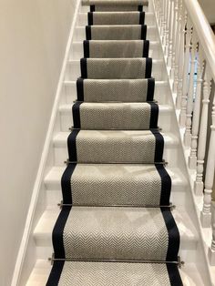 a set of stairs with black and white carpet