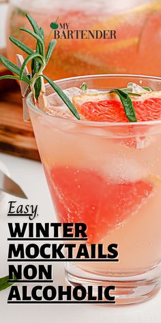 a drink in a glass with grapefruit and rosemary garnish