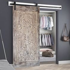 an open closet door with clothes on hangers