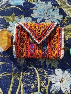 This is a beautiful orange zazi wallet from Afganistan Silk thread embroidery with mirror work and beaded trim Inner details 2 Inner pockets folded in half Fully lined with cotton Great for Amulets and Carrying your Crystals  Size 10 inch length (not including flap)           5 inch width Bohemian Beaded Clutch For Festivals, Bohemian Clutch With Handwork, Bohemian Beaded Pouch Clutch, Bohemian Beaded Festival Clutch, Bohemian Handmade Multicolor Coin Purse, Bohemian Multicolor Handmade Coin Purse, Handmade Multicolor Bohemian Coin Purse, Bohemian Clutch With Handwork As A Gift, Handmade Pouch Clutch For Festivals