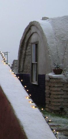 there is a snow covered roof with lights on it