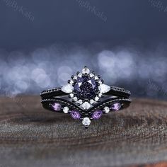 a purple diamond ring sitting on top of a wooden table