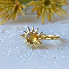 A beautiful transparent natural citrine gemstone adorns a gold plated over sterling sun. Dainty but noticeable! Citrine is the birthstone for the month of November, but is such a vibrant stone it can be enjoyed by all. The color of the citrine pairs beautifully with the sun. The ring is solid sterling that is plated with gold. Sterling silver is a great option for those that have sensitive skin and want a quality piece of jewelry. The sun is tiny and measures about 1/2 inch. The gemstone is genu Gold Celestial Moonstone Ring In 14k, Celestial Gold Rings With Gemstone, Gold Celestial Rings With Gemstone, Handmade Gold Celestial Moonstone Ring, Gold Topaz Birthstone Ring Gift, Gold Moonstone Ring Fine Jewelry With Birthstone, Gold Sterling Silver Hallmarked Moonstone Ring, Gold Celestial Moonstone Ring In Sterling Silver, Celestial Gold Moonstone Ring