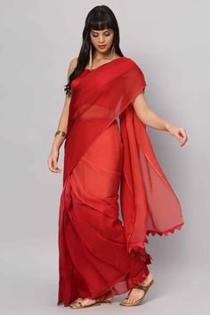 Introducing our stunning Red 4-Shade Organza Saree, a timeless piece that shows grace and charm. Crafted from high-quality organza in four captivating shades of red, this saree is a true work of art. Paired with a sleeveless blouse made from rich red raw silk, it's a perfect outfit to make a bold and elegant statement at any occasion. About this Product Saree: Saree Color: Red Saree Fabric: Georgette Organza Type of Work: Four colors shaded Trim: Tassel-work on pallu Drape Style: Choose the drap Red Art Silk Pre-draped Saree With Self Design, Red Pre-draped Saree With Sheer Dupatta For Puja, Elegant Red Pre-draped Saree For Festive Occasions, Red Georgette Pre-draped Saree With Pallu, Bollywood Style Red Pre-draped Saree With Self Design, Red Georgette Pre-draped Saree With Sheer Dupatta, Red Unstitched Pre-draped Saree For Diwali, Festive Red Chanderi Pre-draped Saree, Red Organza Pre-draped Saree